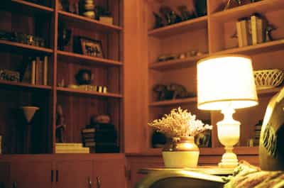 Cozy armchair next to lamp in warm interior light on ColorPlus 200